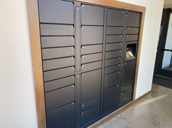 A black metal locker with a wooden frame.
